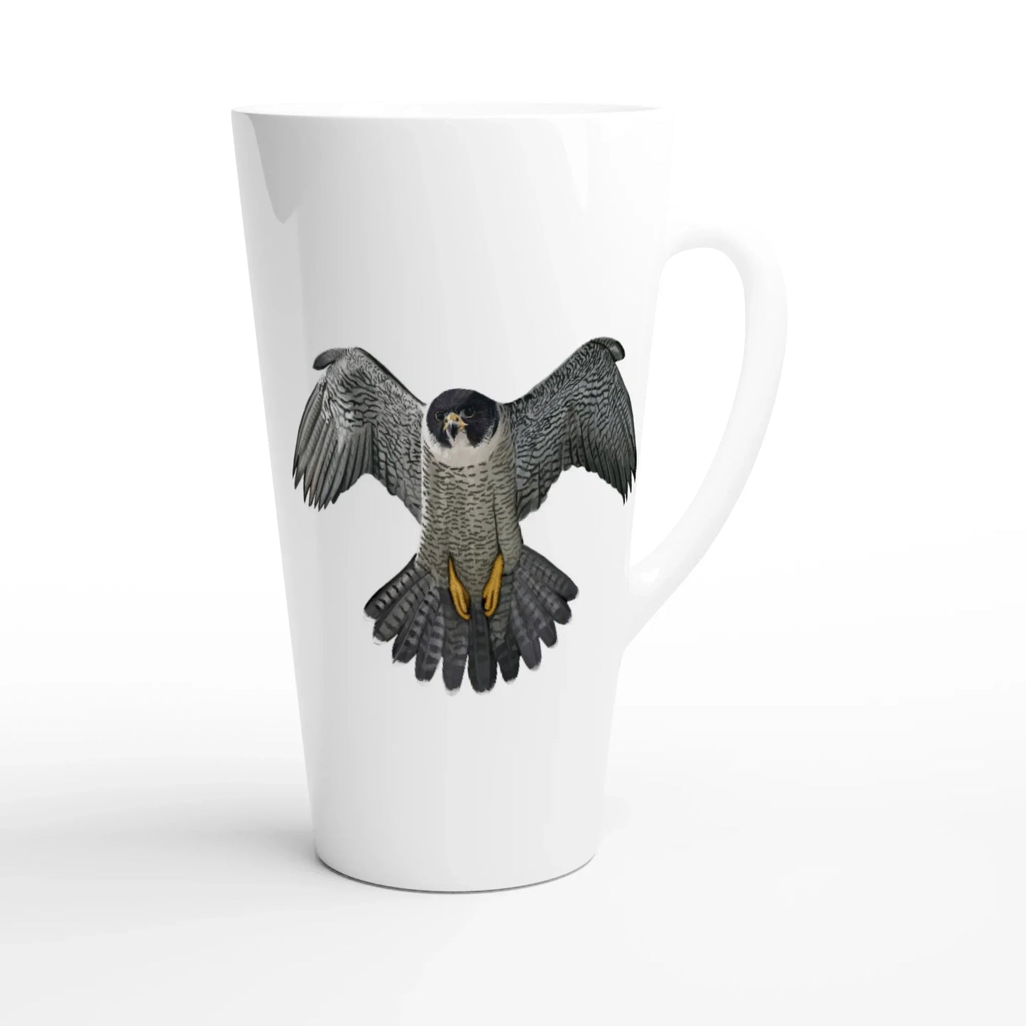 White latte mug featuring a detailed illustration of a peregrine falcon in flight, showcasing wildlife art design.