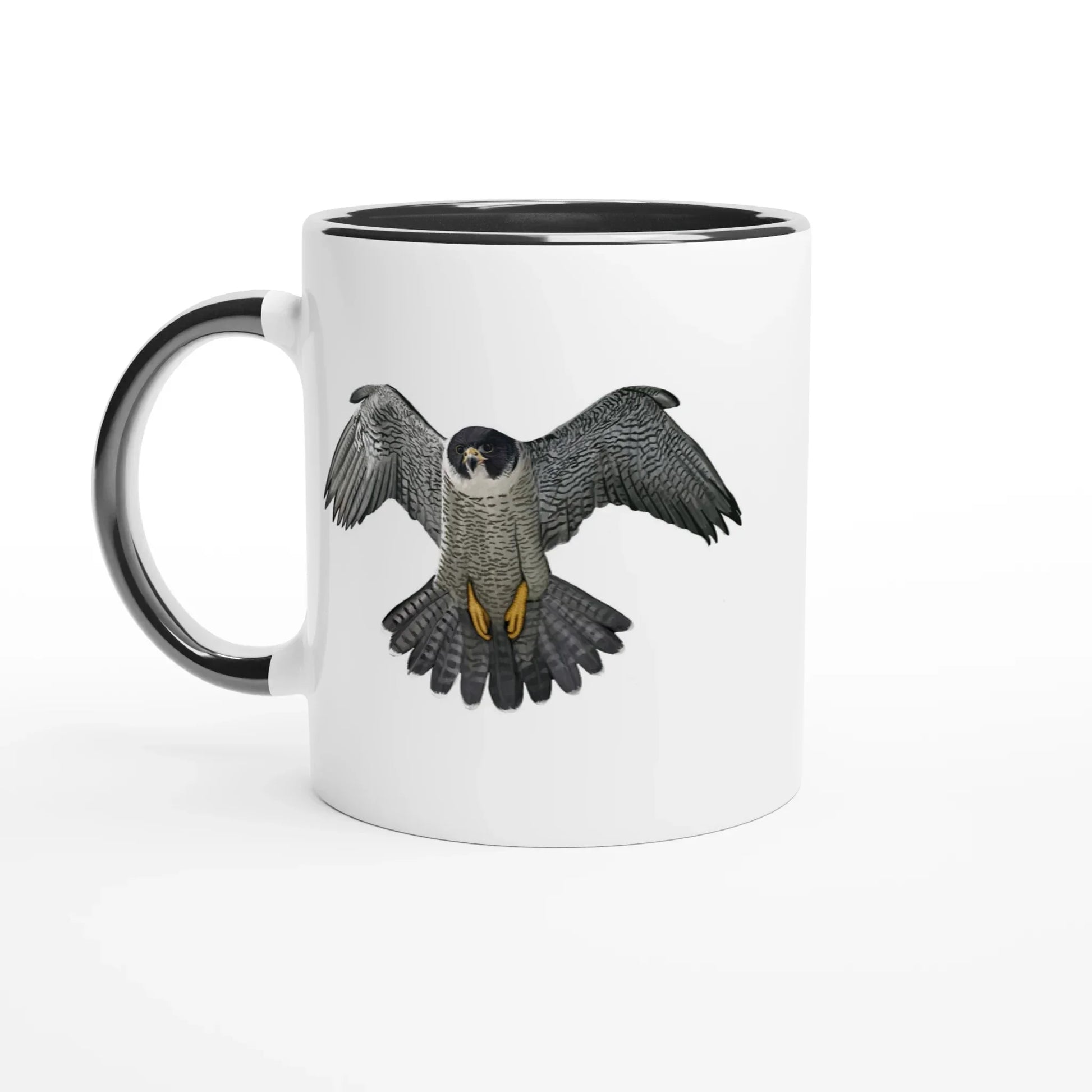 White mug with black rim featuring a detailed illustration of a peregrine falcon in flight, wings spread wide.