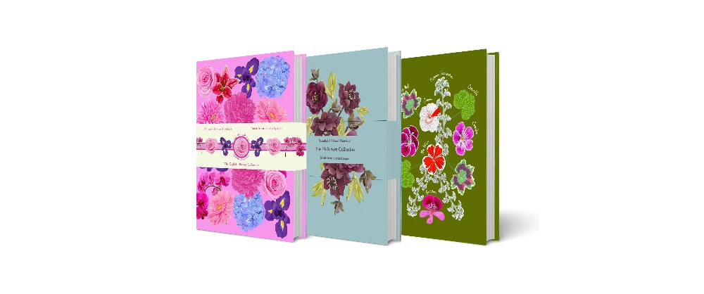 Three colorful notebooks with floral designs on a white background